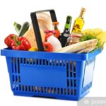 Plastic shopping basket with variety of grocery products